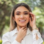 Portrait of smiling Hispanic woman in white blouse outdoors in Ciudad de México.
